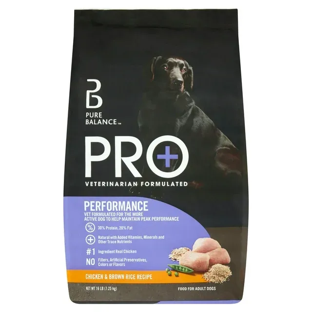 A bag of Pure Balance dog food with a dog looking at it happily