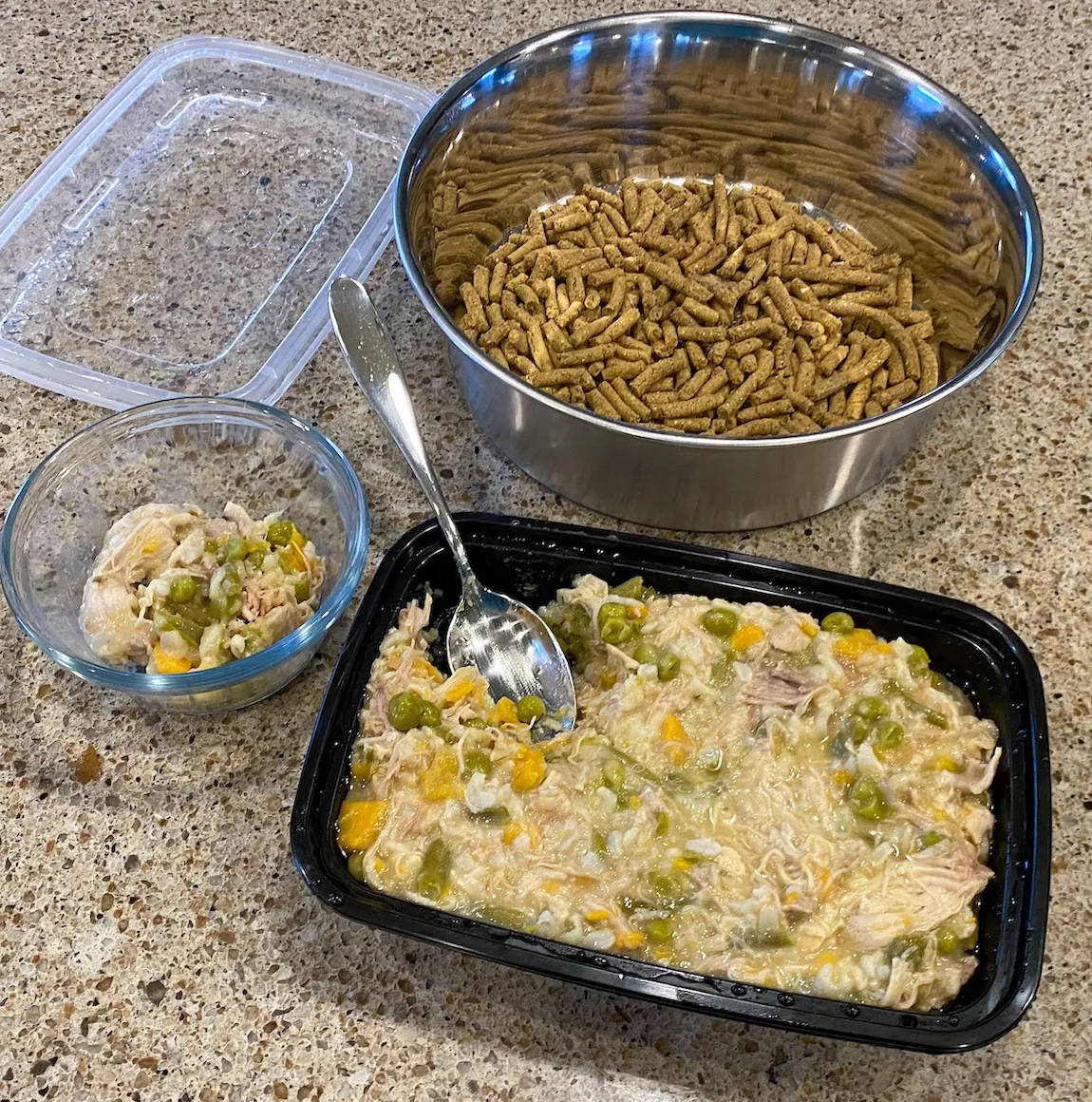 A bowl of dry dog kibble mixed with a serving of homemade Instant Pot chicken and rice for dogs