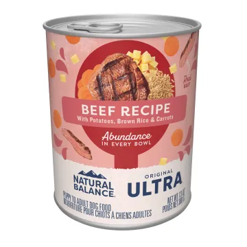 A can of Natural Balance Original Ultra Beef dog food open, showing the chunky texture and visible pieces of meat and vegetables.