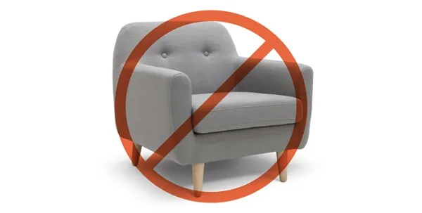 A close-up of chewed wooden furniture leg, indicating destructive chewing behavior in dogs.