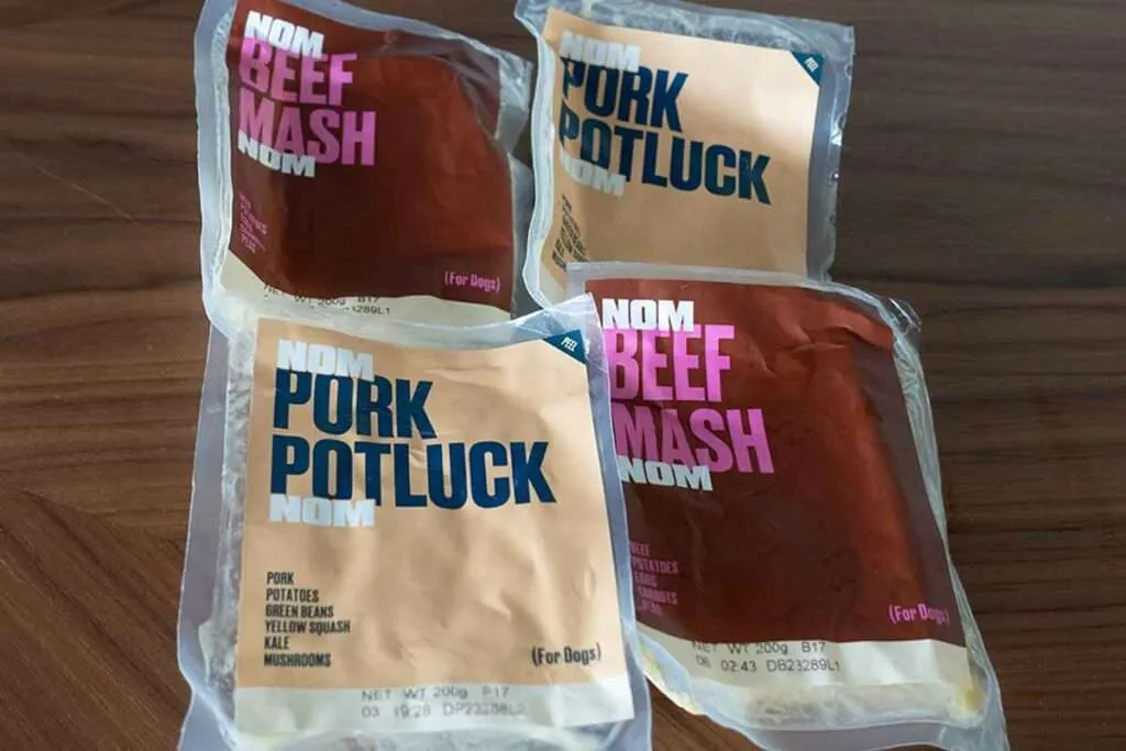 A close-up of Nom Nom dog food with visible fresh ingredients, indicating high quality.