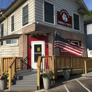 A cozy interior shot of The Dog Eared Book store, showcasing shelves filled with books and a reading nook.
