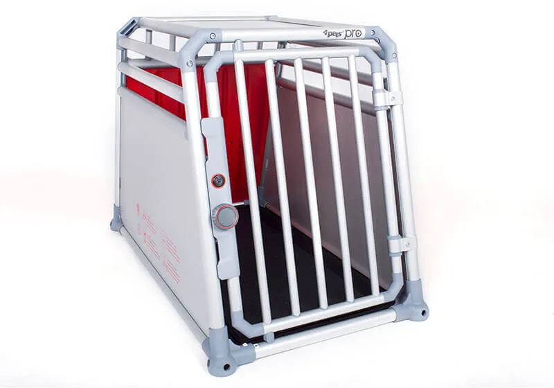 A golden retriever sitting calmly inside a spacious 4pets PRO dog cage in a car boot.