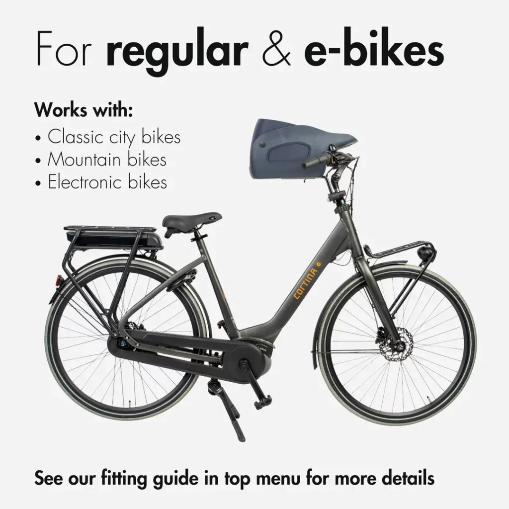 A happy dog enjoying a bike ride in the Kvisp front bike carrier, showcasing the excellent forward view for pets on UK roads.