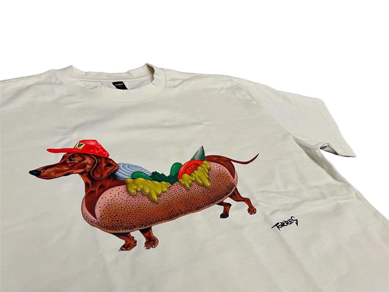 A happy wiener dog graphic on a red t-shirt, representing fun dog-themed merchandise available online.