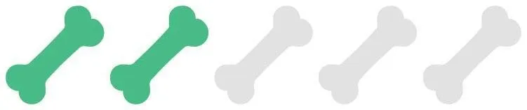 A muscular Staffordshire Bull Terrier with a short, glossy coat standing alert.