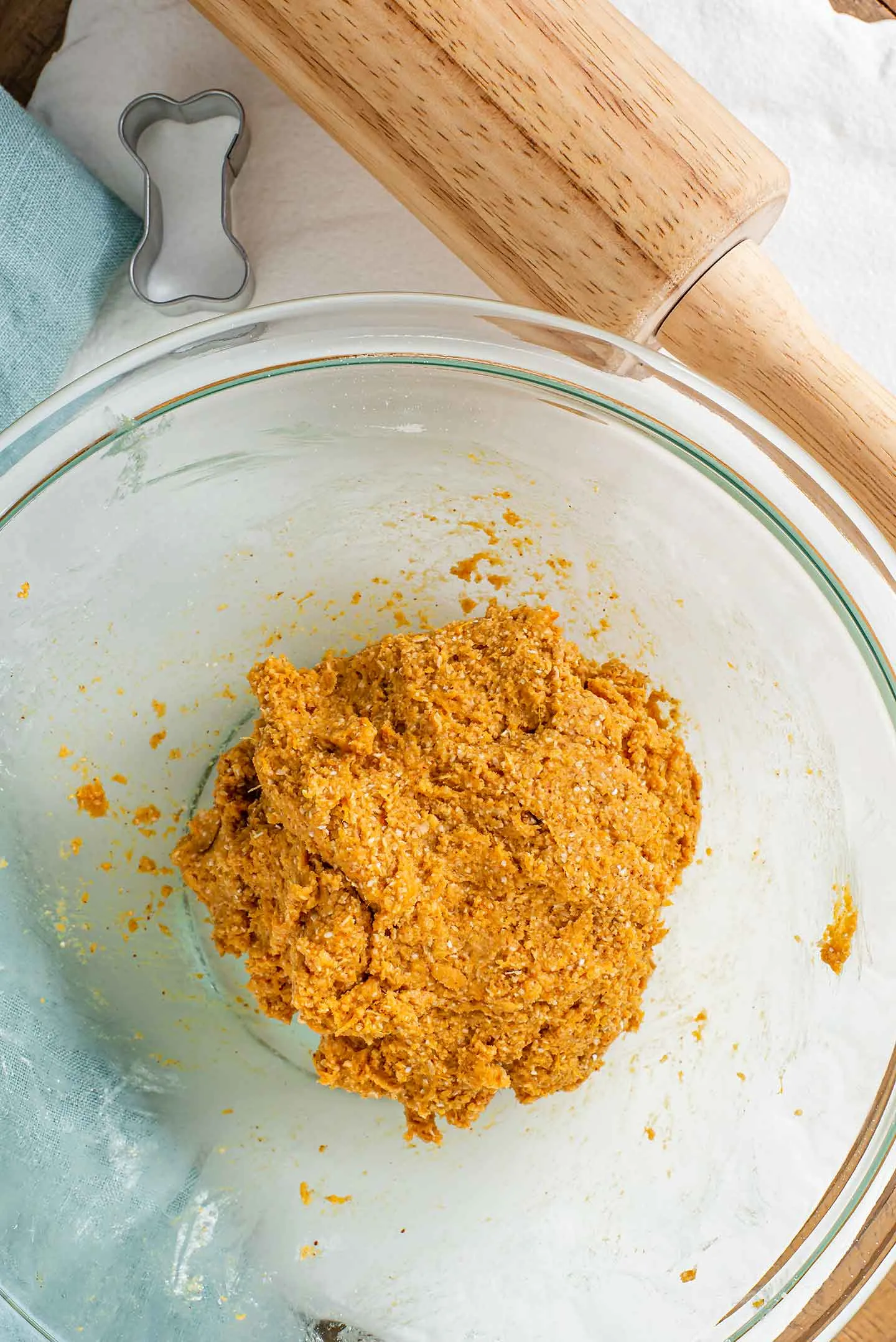 A perfectly kneaded ball of golden-brown 3-ingredient dog treat dough, ready for rolling and cutting.