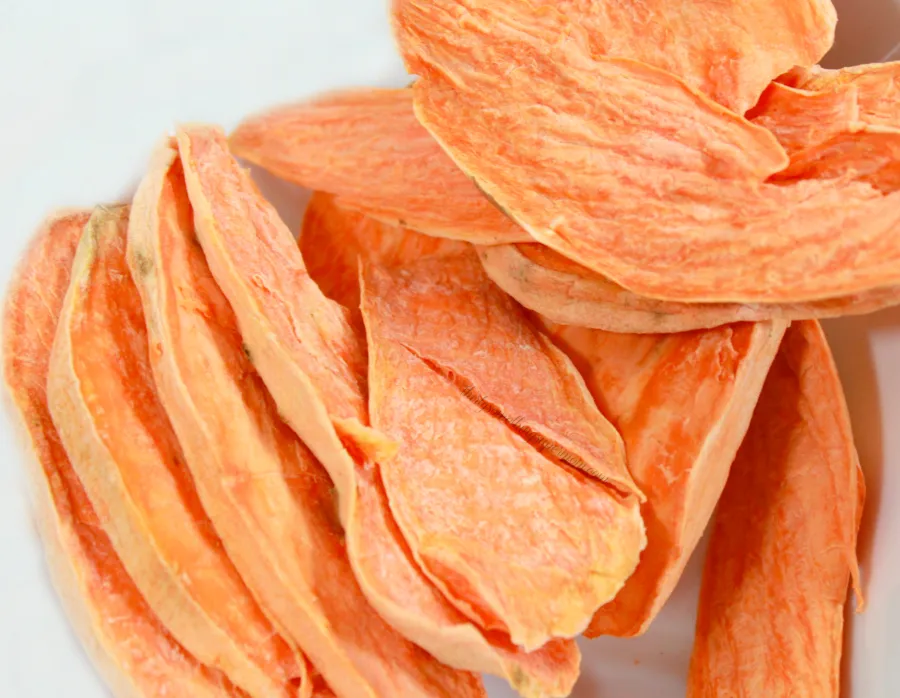 A pile of finished air fryer sweet potato dog treats, showcasing both chewy and crispy textures, perfect for a homemade canine snack.