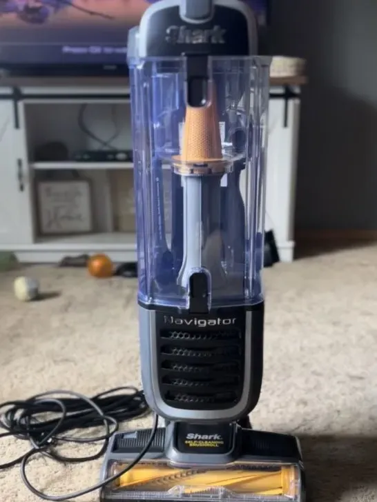 A powerful pet vacuum cleaner in action on a carpet, highlighting its effectiveness