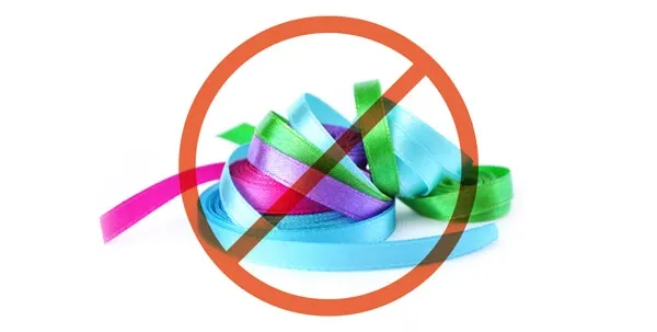 A roll of decorative ribbon, highlighting string-like items that are dangerous for dogs if ingested.