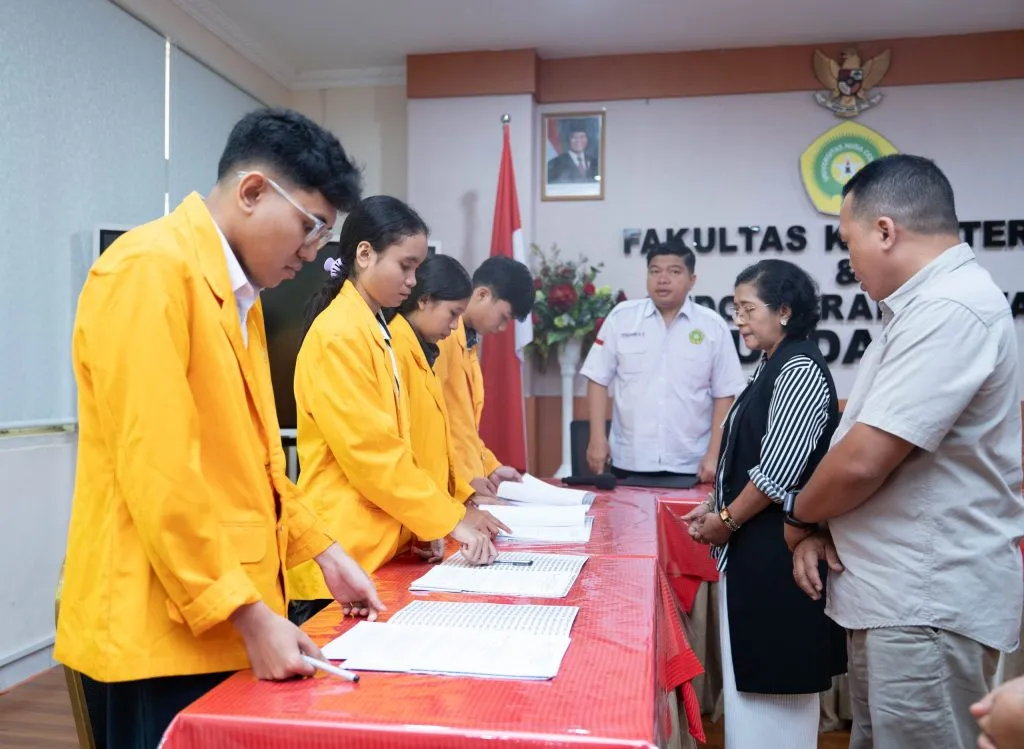 A student receiving the Radhiyan Pet Care scholarship contract during the official ceremony.