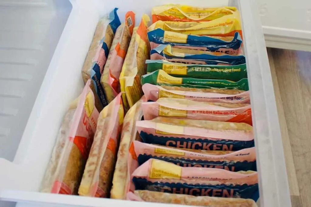 A variety of Butternut Box fresh dog food recipes displayed on a freezer shelf