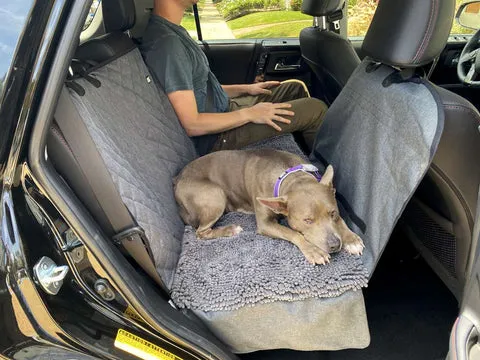 A visual representation of a dog car seat hammock, illustrating how it creates a safe, enclosed space for a dog in the back seat.