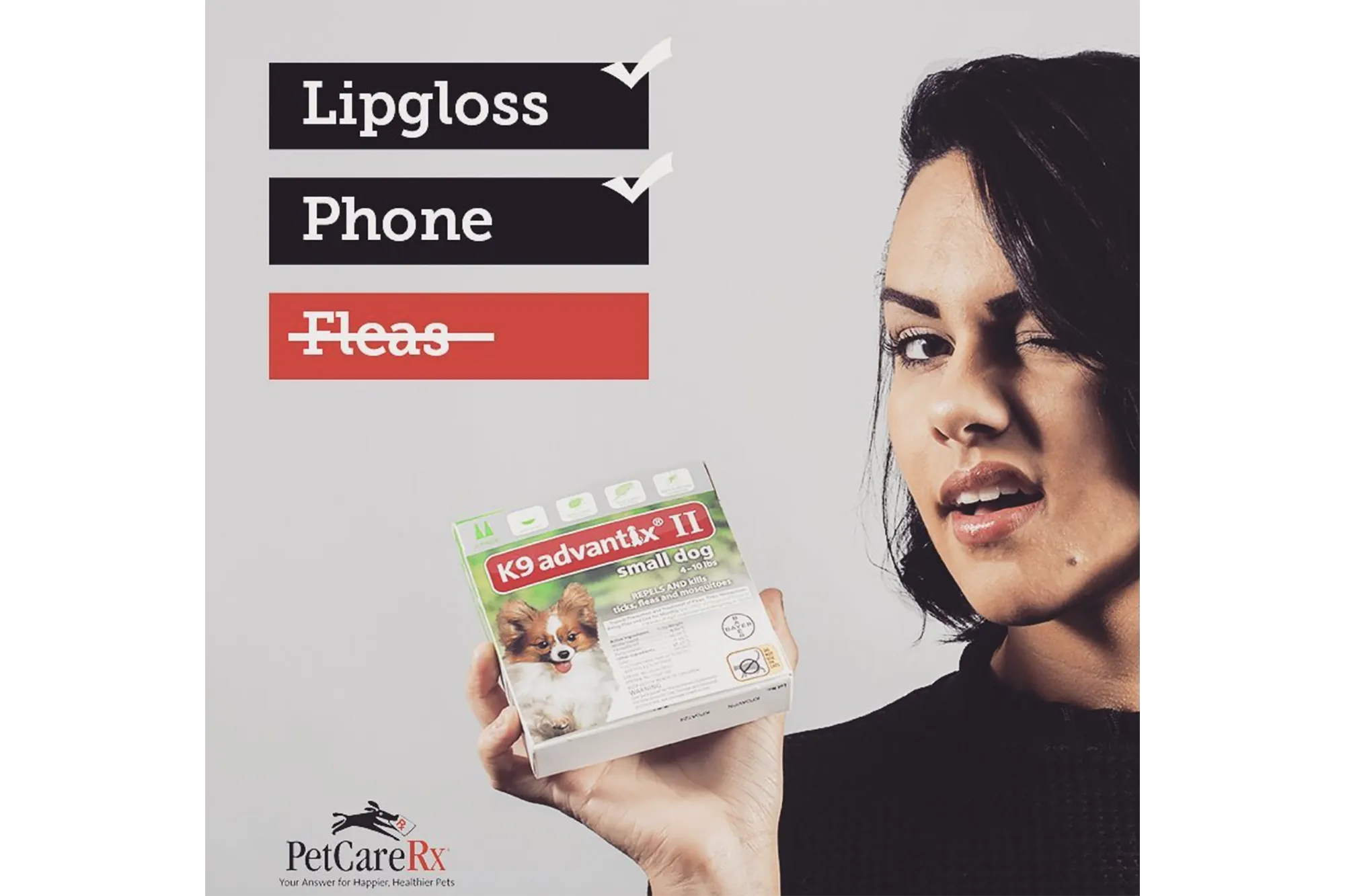 A woman holding pet flea medication, illustrating PetCareRx's offerings for dog health essentials and medical accessories.
