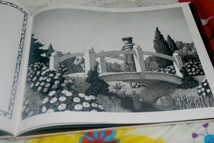 Alan looking down at the 'bad-mannered' dog Fritz, a key character in Chris Van Allsburg's Caldecott Honor book