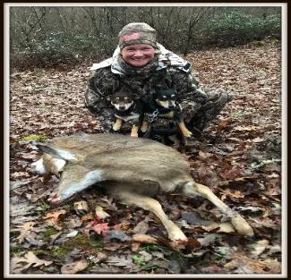 An agile short legged short haired Jack Russell Terrier perched on a rock, demonstrating its readiness for action.