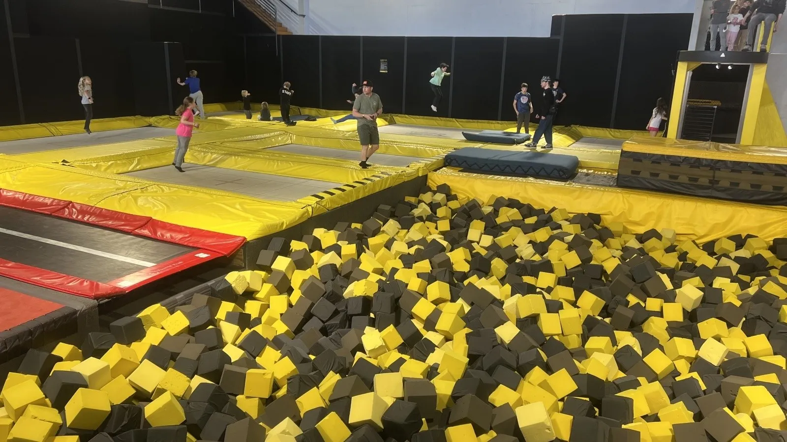 An older dog owner proudly posing with their senior Golden Retriever after a successful training session.