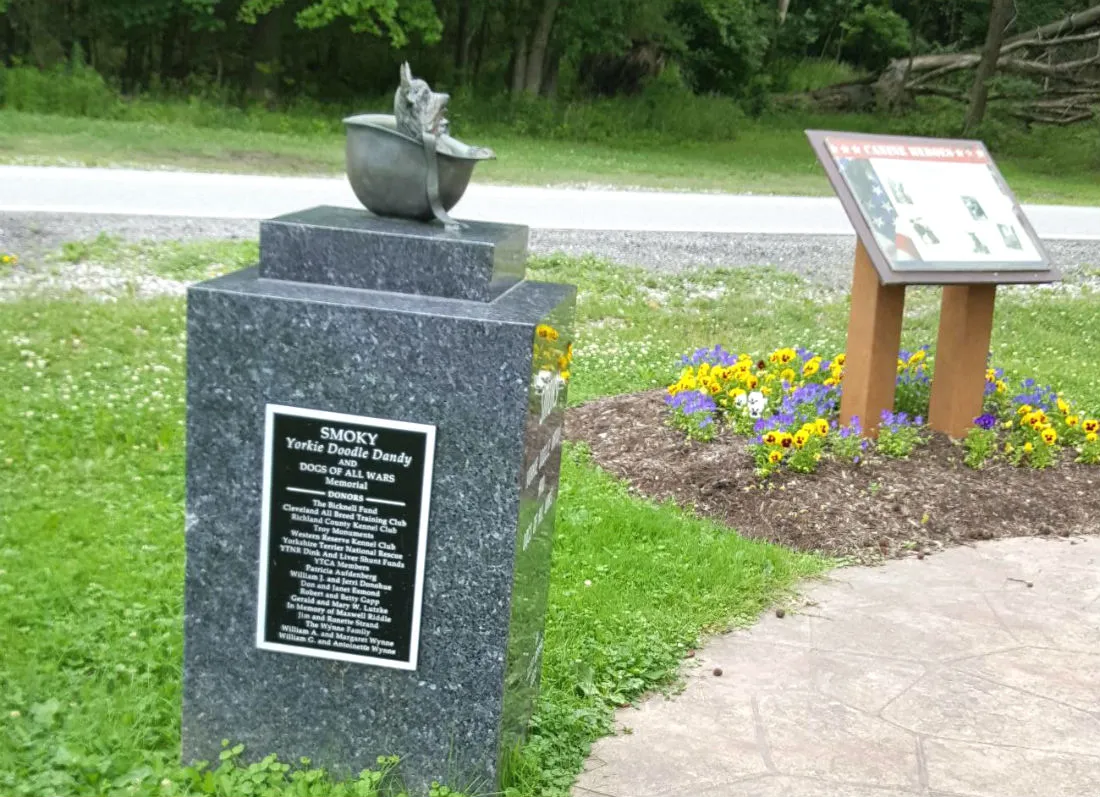 Another perspective of the Smoky the war dog statue, emphasizing her small size and the helmet