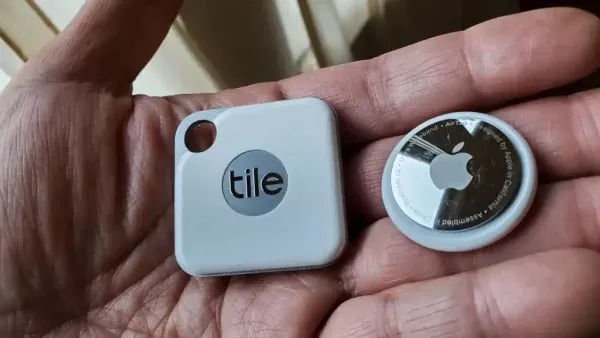 Apple AirTag and Tile trackers side-by-side, representing tools used in a lost dog short story.