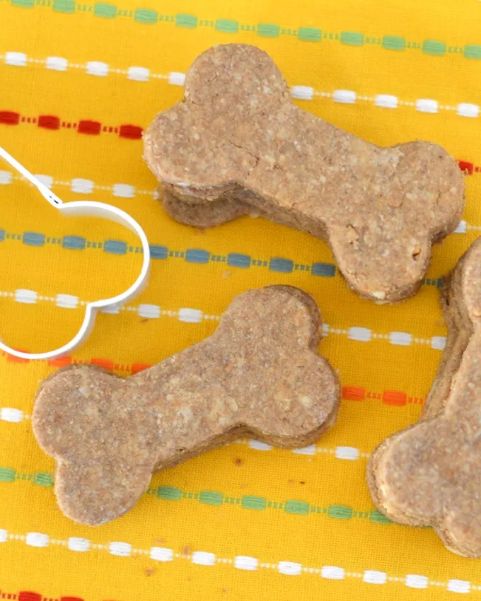 Assortment of dog-themed cookie cutters, including bone and paw shapes, for baking dog treats