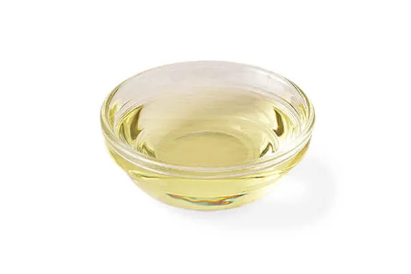 Bottle of canola oil and canola flowers, providing essential fatty acids in dog food