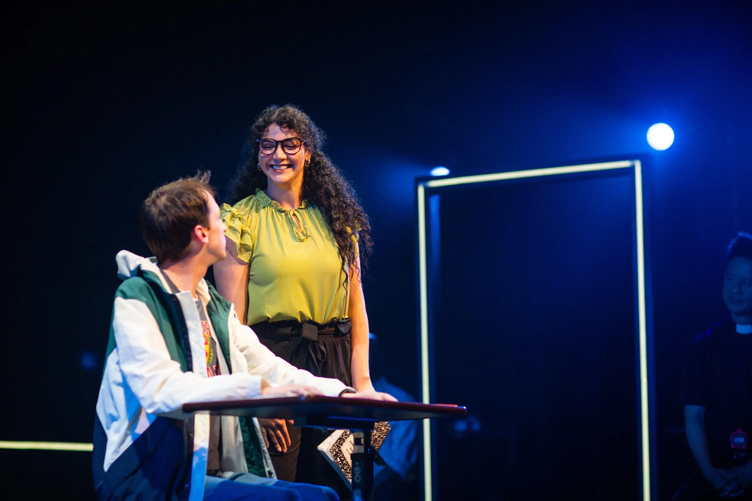 Christopher Boone listens intently to his teacher, Siobhan, who offers guidance and support