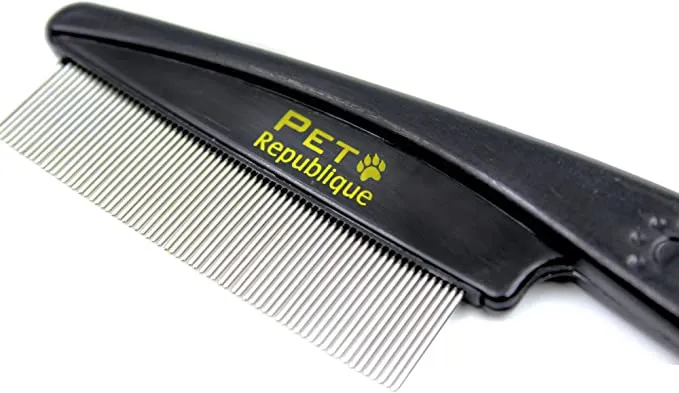 Close-up of a person using a flea comb on a dog's fur