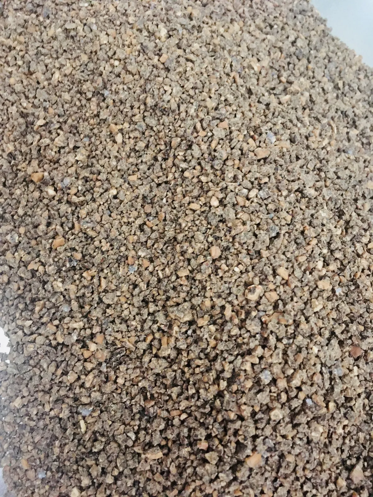 Close-up of naturally clumping walnut cat litter, an eco-friendly and safe choice for use in chewy cat litter box furniture.