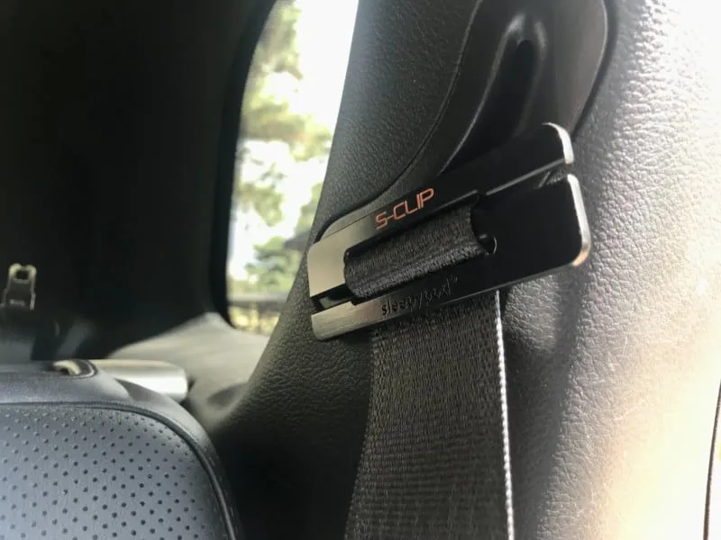 Close-up of the Sleepypod S-Clip accessory, designed to secure dog car seat belts for large breeds.