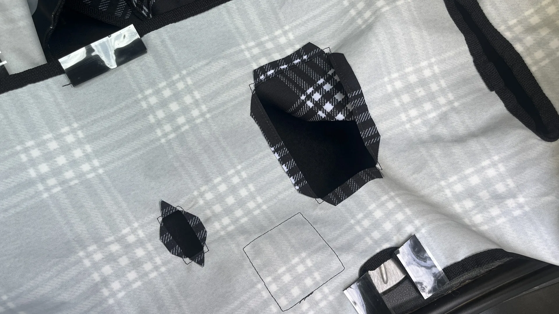 Close-up of the stitching and material of a canvas back seat dog cover.