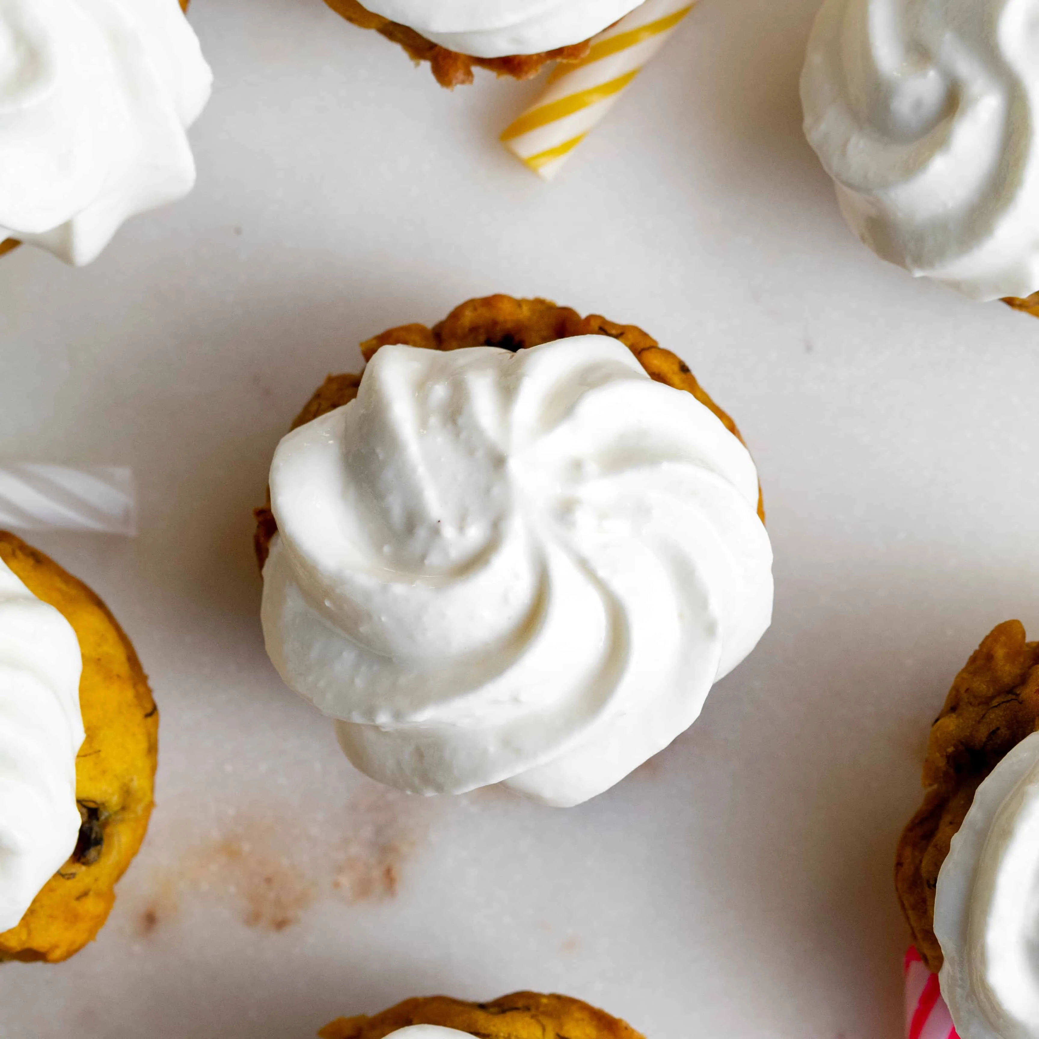 Close up top-down image of banana pumpkin frosted pupcake