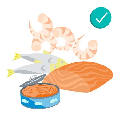 Cooked shrimp and fish fillets, indicating safe seafood options for dogs when prepared plainly.