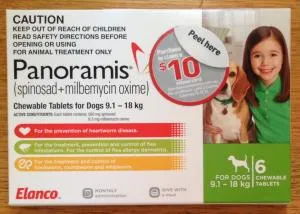 Dog taking a Comfortis Plus tablet for flea, heartworm, and worm prevention