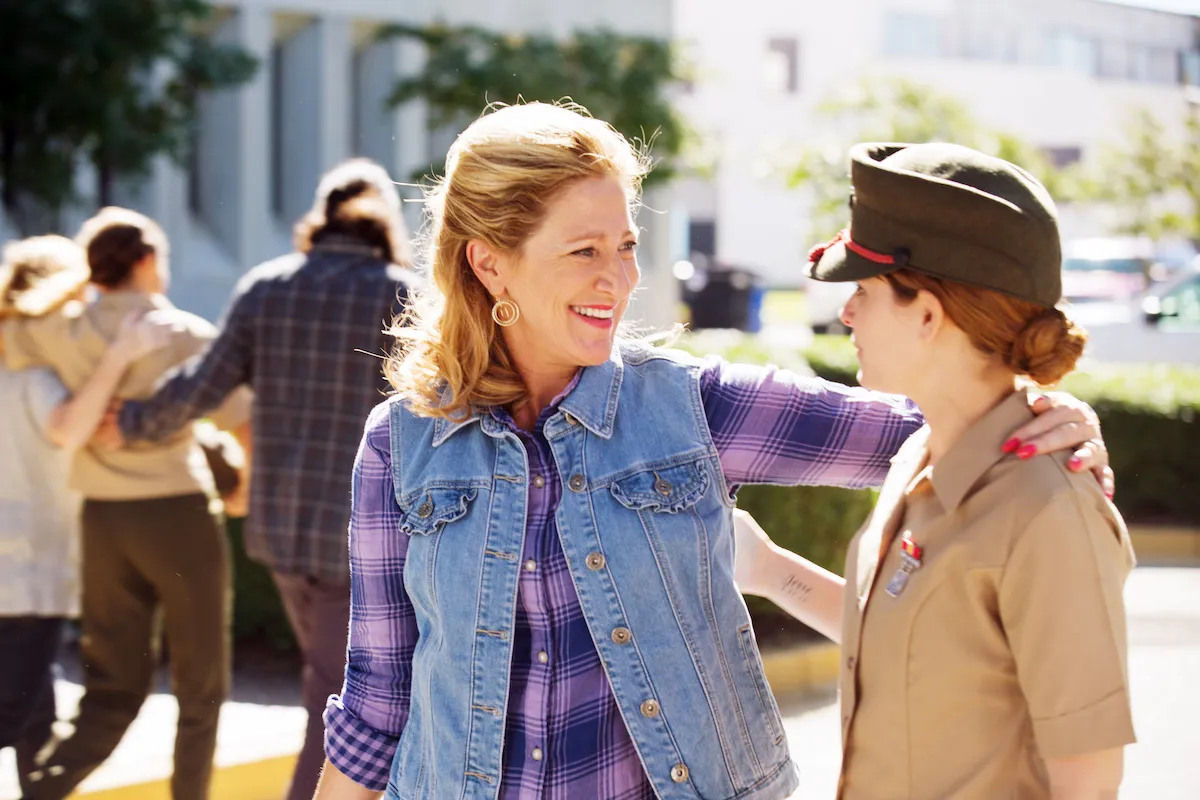 Edie Falco and Kate Mara in Megan Leavey, showing a comforting embrace between two characters.