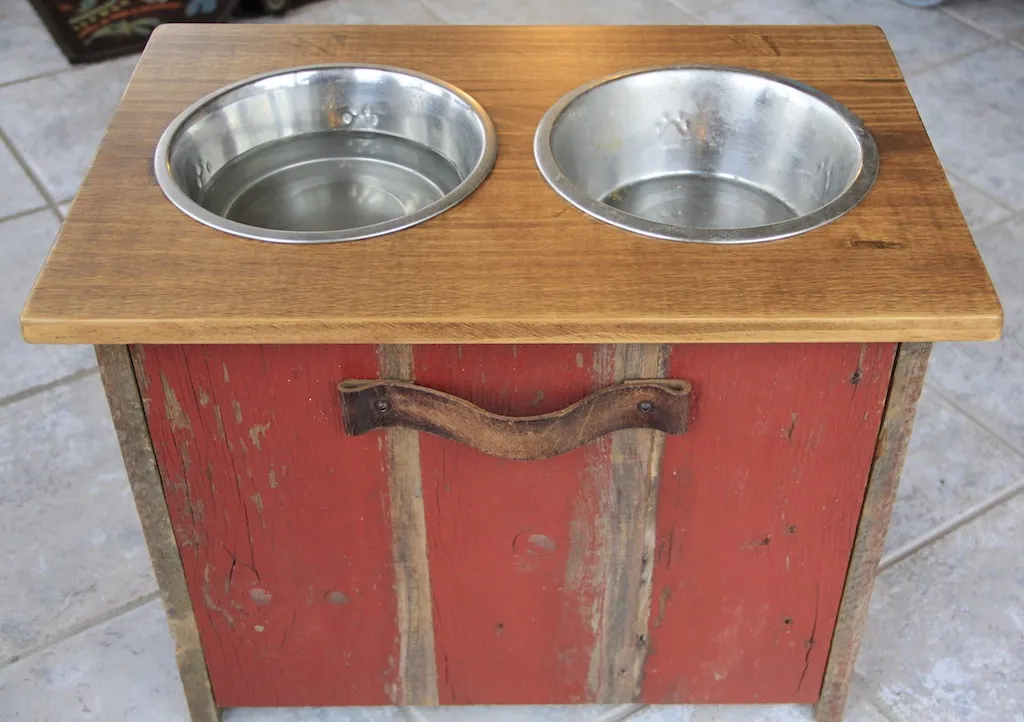 elevated dog bowl station with metal bowls made of reclaimed barn wood