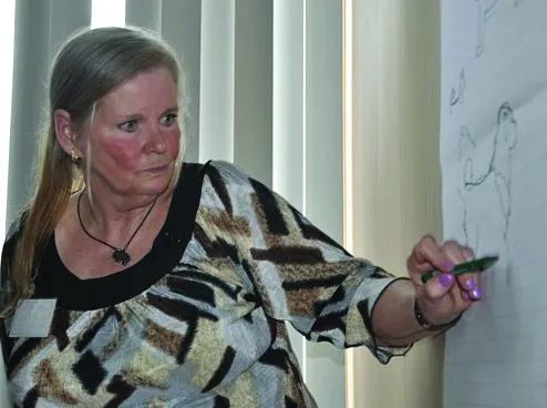 Expert judge Kristina Sherling giving a seminar on Tibetan Mastiff history and correct breed structure after a dog show, emphasizing health and traditional characteristics.