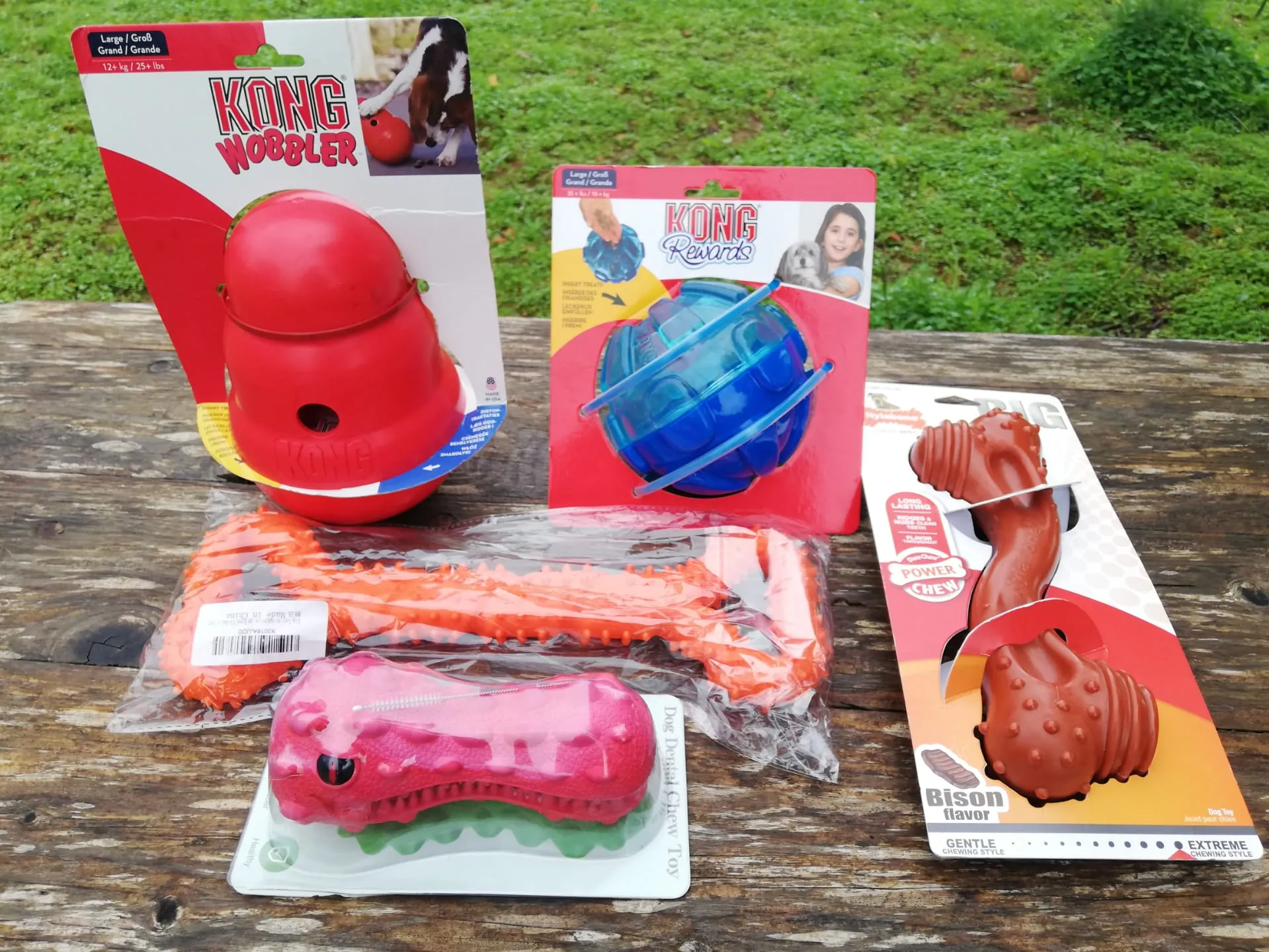 Five indestructible dog toys laid out on the ground