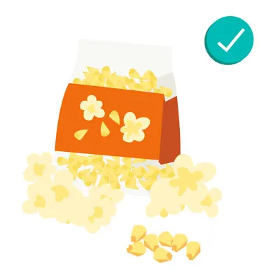 Fresh corn on the cob and air-popped popcorn, showing safe grain options when unseasoned.
