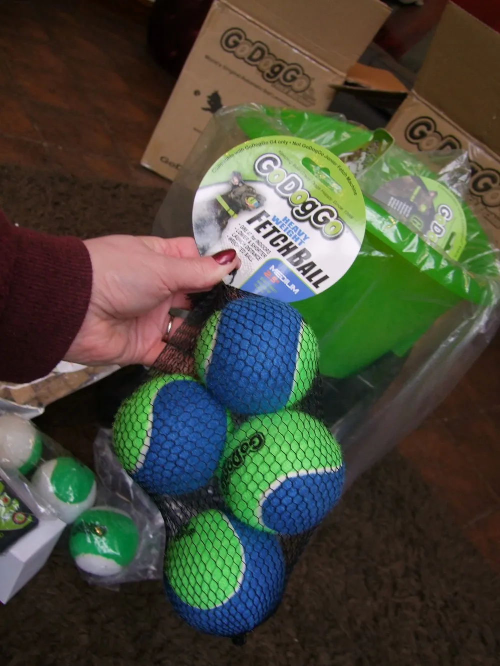 GoDogGo machine with a colourful assortment of tennis balls, including glow-in-the-dark options, ready for play