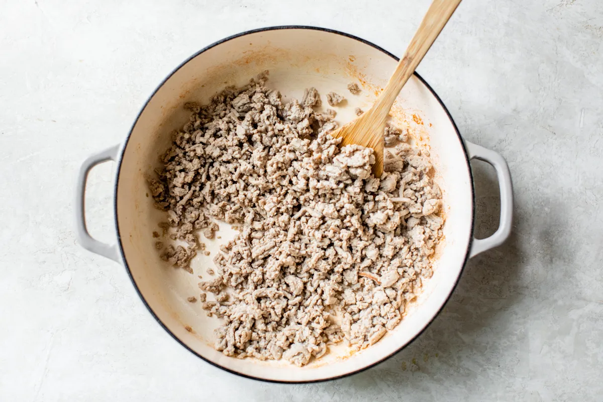 Ground turkey browning in a large pot.