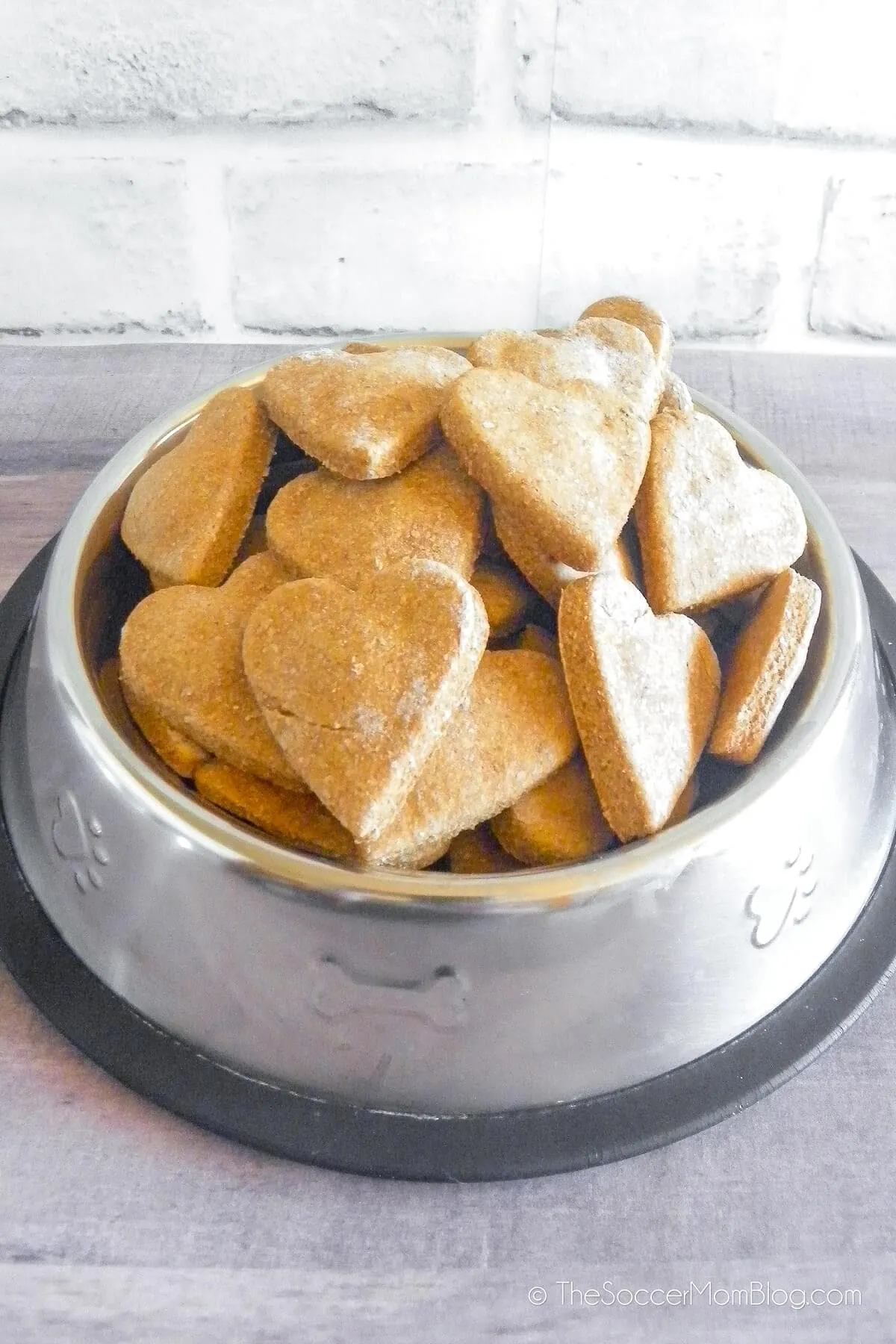 Heart-shaped homemade sweet potato dog treats in a pet bowl