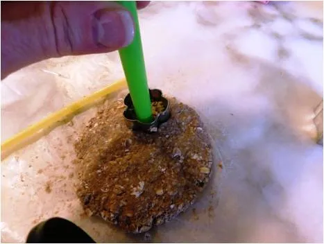 Homemade banana dog treats shaped like bones on a baking sheet.