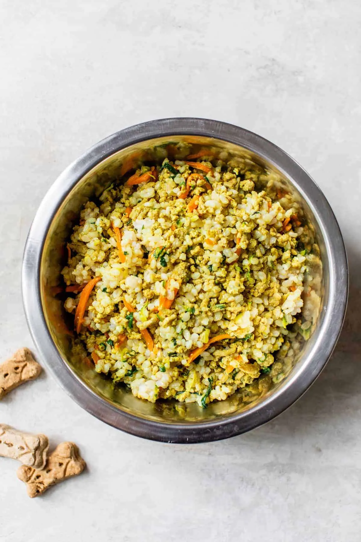 Homemade dog food in a small bowl, perfect for small dogs, with healthy treats nearby.