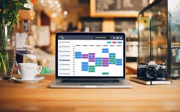 Laptop screen displaying pet sitting management software, illustrating tools for efficient scheduling and client communication