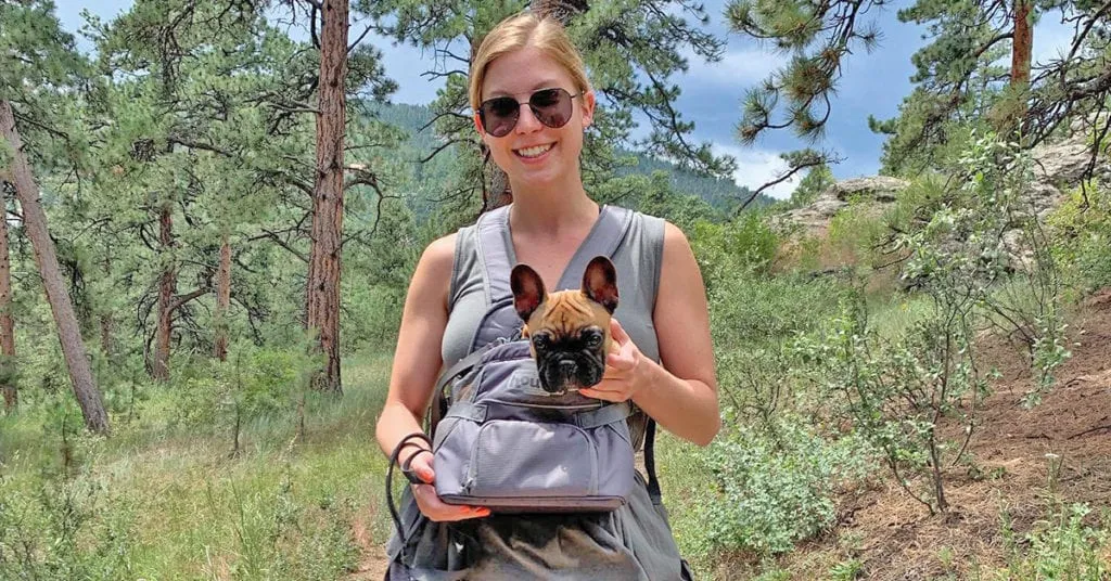 Lunday carrying Louis in an Outward Hound pet carrier on a hiking adventure, showcasing versatile gear for outdoor dogs.