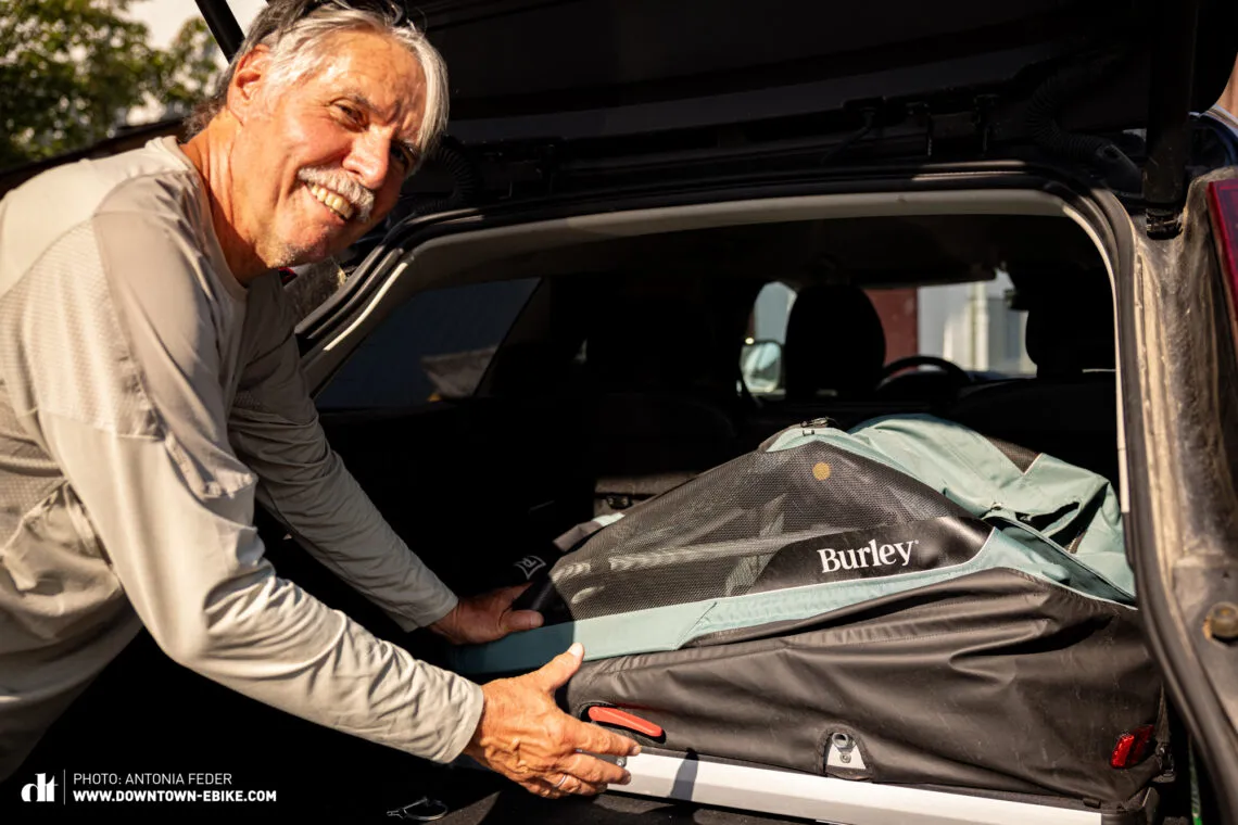 Manne stores the Burley dog bike trailer in the boot of his car, demonstrating its portability.