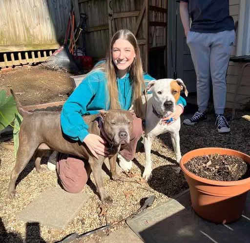 Max and his sister enjoying playtime in a spacious backyard