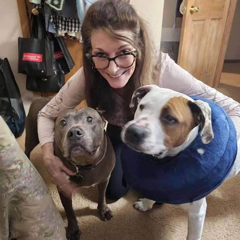 Max with his owner Tara and his doggy sister Star, looking calm together