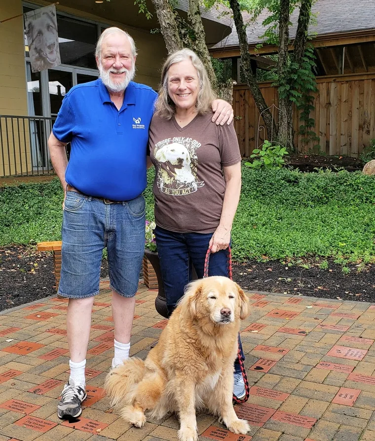 Michael and Zina Goodin, founders of Old Friends Senior Dog Sanctuary, with Barry, a rescued senior dog.
