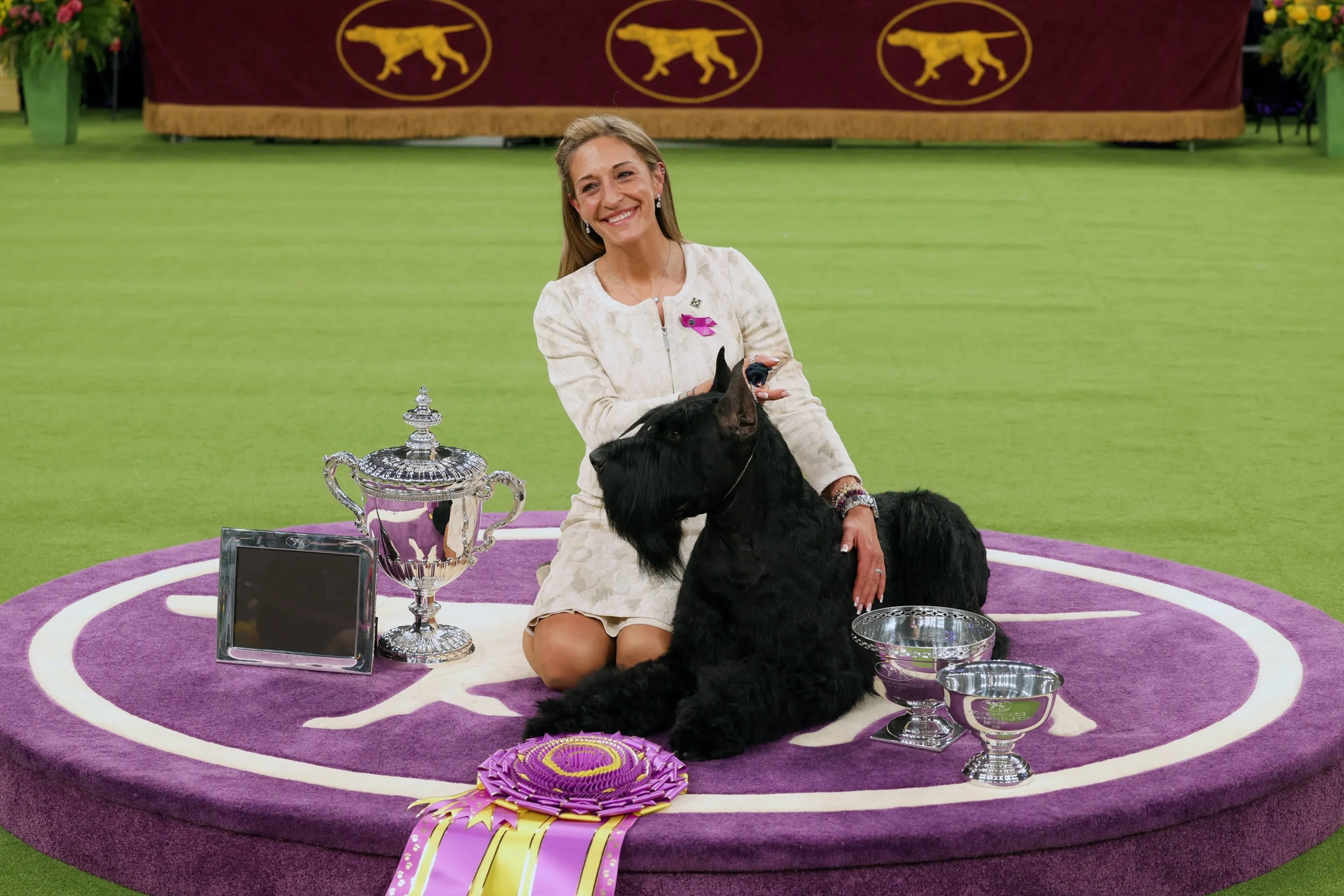 Monty the Best in Show Giant Schnauzer posing with his handler Katie Bernardin at the 149th Westminster Dog Show